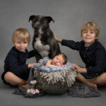 newborn with siblings and a dog