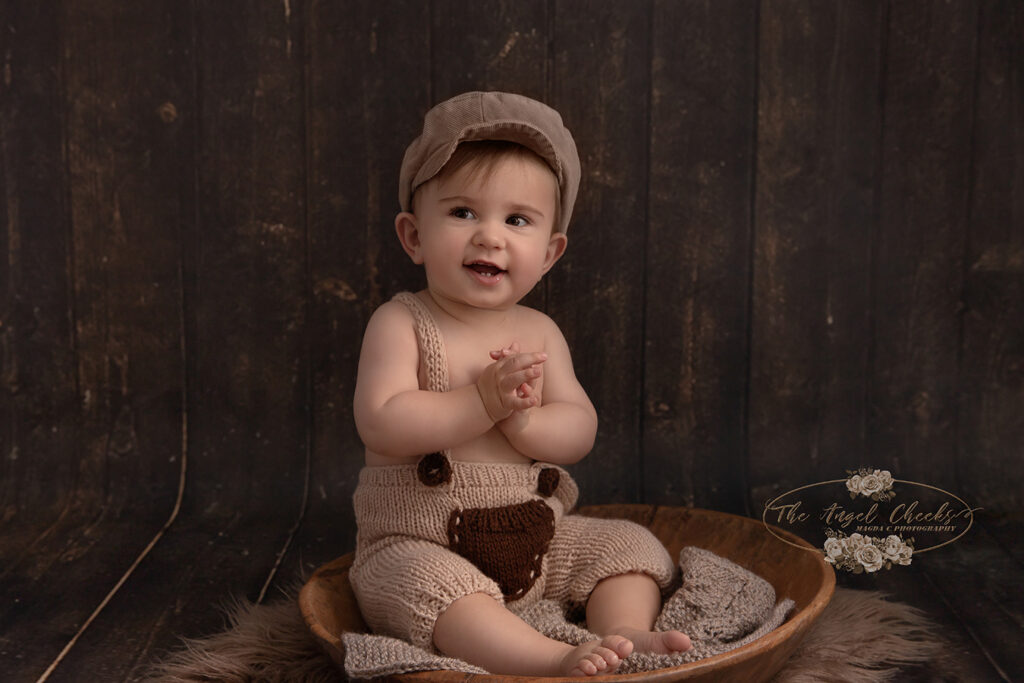 siting baby in a wooden bowl